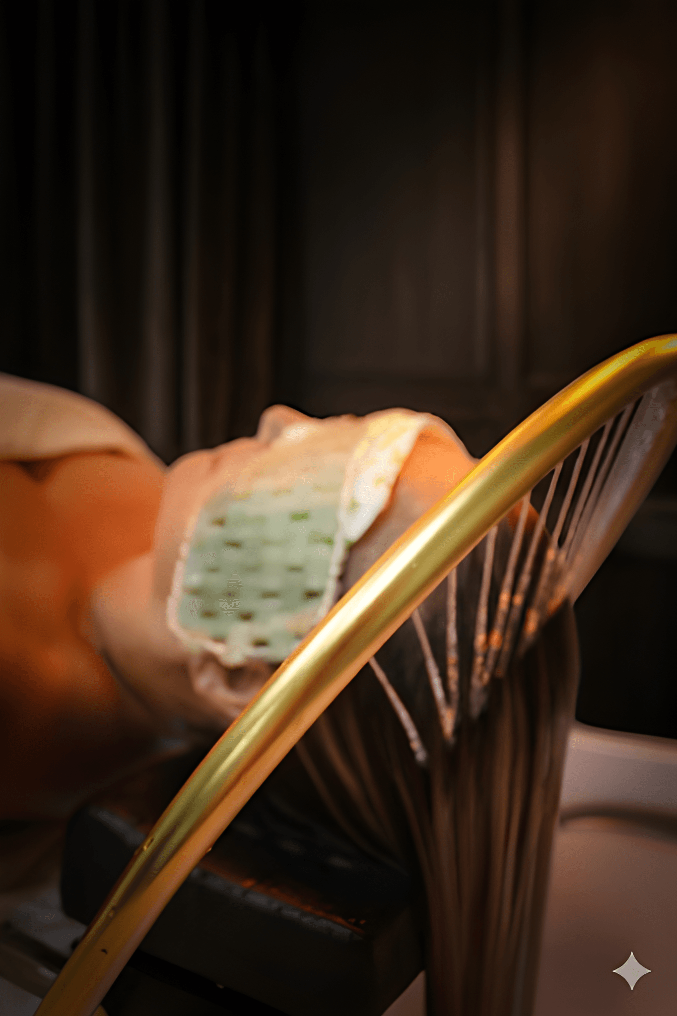 A guest reclined at the basin with a sheet mask on while the gold halo ring streams water through her hair during a head spa treatment at Serenity Scalp Spa, the full service students learn to deliver